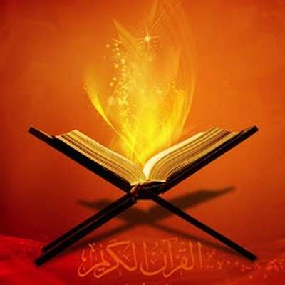 Qura’an Open Quran on wooden stand with glowing light